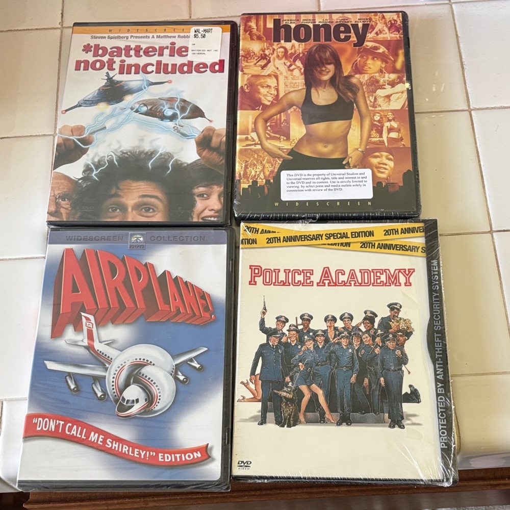 Set of 4 Comedy DVDs – Airplane!, Police Academy, Honey, *batteries not included